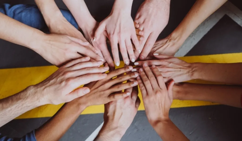 Hands stacked together showing teamwork.