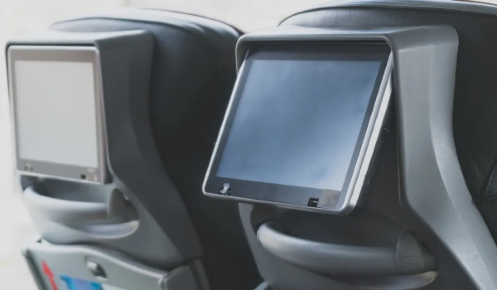Touchscreen displays on the back of coach seats.