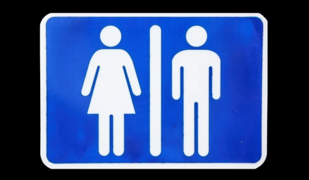 Blue unisex toilet sign with male and female white icons on black background.