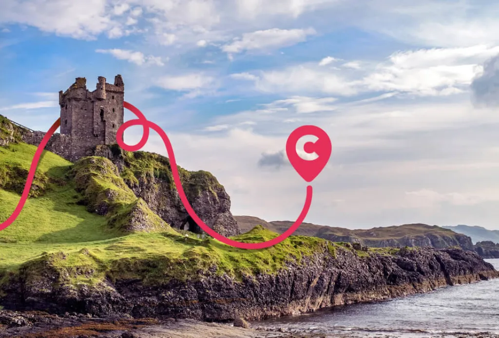 Coastal castle ruins on rocky cliffs in Scotland with Coachhop route pin overlay.